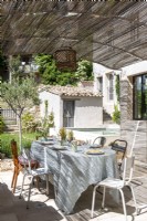 Outdoor dining area on terrace of country house in summer