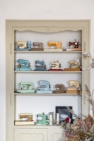 Display of miniature sewing machine models on shelf