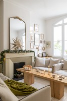 Star and garland over fireplace in neutrally decorated living room
