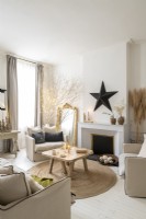 Black star decoration above fireplace in modern country living room