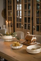 Gingerbread biscuit house on dining table at Christmas