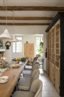 Stripped wooden doors in modern country dining room at Christmas 