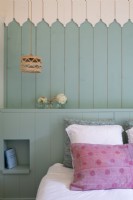 Painted wooden walls in country bedroom