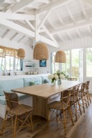 Built-in bench seat by wooden dining table in country kitchen-diner
