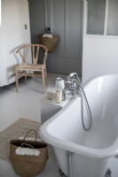 Roll-top bath in white and grey bathroom