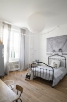 Black iron bedstead in white childrens bedroom