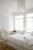 Large white wreath in white bedroom