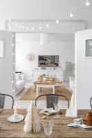 Christmas decorations on dining table in white open plan space