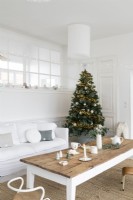 Decorated Christmas tree in white painted living room