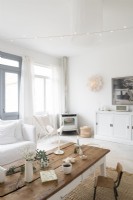 White modern country living room with wood burner in corner