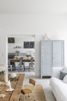 White and grey living space with view to kitchen-diner