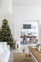 Christmas tree in modern country living room with view to kitchen