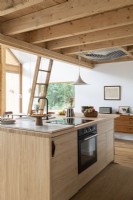 Small wooden kitchen in open plan country cabin