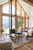 Modern country living room with view of mountains through windows