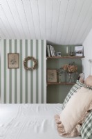 Country bedroom with striped wallpaper and vintage furniture