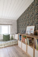 Daybed, cushions and large bookcase in childrens room