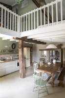 Country kitchen-diner under wooden mezzanine
