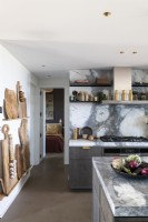 Marble worktops and splashbacks in contemporary kitchen