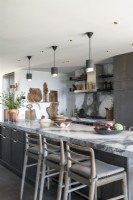 Marble top island and breakfast bar in contemporary kitchen