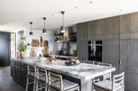 Large marble top island in contemporary kitchen