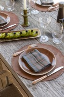 Detail of place setting on outdoor dining table in summer