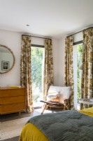 Vintage style fabric curtains and furniture in modern bedroom
