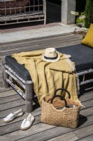 Hat, bag and accessories on sunbed outdoors