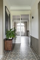 Sideboard with plants in hallway with original tiled flooring