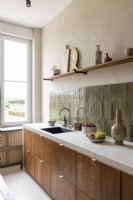 Stone tiled splashbacks in modern wooden kitchen