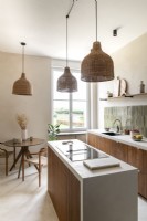 Narrow island and small round table and chairs in modern kitchen