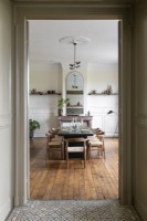 View into dining room with wooden flooring and period details