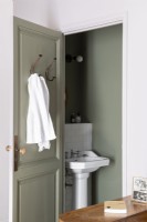 View into grey painted bathroom with classic style sink 