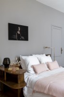 Black and white photograph above bed in vintage bedroom