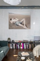 Large artwork on stripped painted wall in eclectic living room