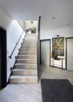 Modern hallway with view up wooden stairs