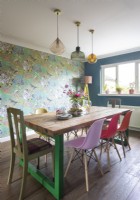 Colourful dining room with wallpapered feature wall 