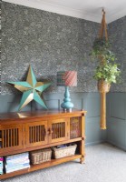 Wooden sideboard with decorative star ornament and houseplant