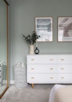 Modern white chest of drawers in bedroom