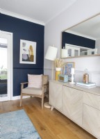 Modern furniture and navy blue painted feature wall in dining room
