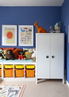 Wardrobe and toy storage in colourful childrens room