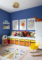 Colourful childrens room with built-in seat above storage boxes
