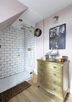 Gold painted chest of drawers in eclectic bathroom