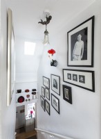 Black and white framed photographs on staircase wall