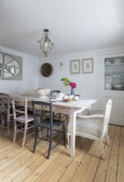 Mismatched chairs around dining table in country dining room
