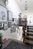 Ornate staircase and display of framed pictures