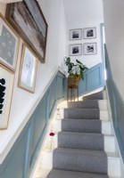 View up staircase with walls covered in framed artwork