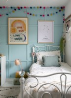 Blue painted panelled wall in modern childrens bedroom