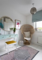 Vintage wicker armchair in colourful dressing room