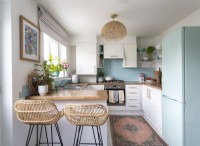 Wicker barstools in small pale blue and white kitchen