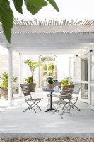 Table and chairs for dining al fresco on veranda 